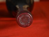a close up of a bottle of wine on a red cloth