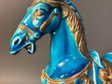 a blue horse that is sitting on a table