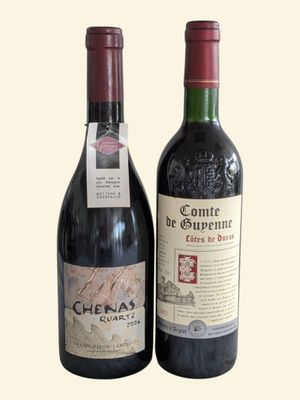 two bottles of wine sitting next to each other on a table