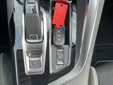 the interior of a car with a red phone in the center console