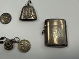 a silver lighter and a keychain with a coin on it