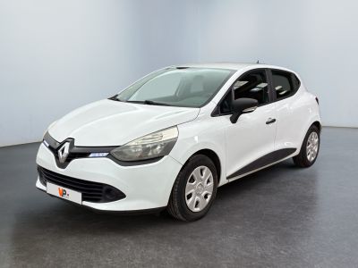 La voiture blanche est garée dans une pièce au sol noir.