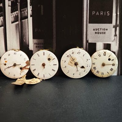 quatre horloges posées les unes à côté des autres sur une table