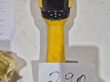 a yellow and black object on a table with a sign