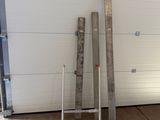 several pieces of metal are stacked up against a garage door