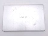 the back of a laptop computer sitting on top of a white table