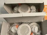 two boxes of toilet paper sitting on the floor