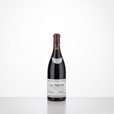 a bottle of red wine sitting on top of a table