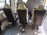 four seats on a bus that are sitting in the sun