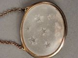 a small gold purse with a chain hanging from it