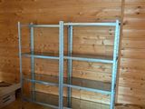 a room with wooden walls and a metal shelving in it