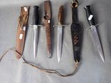 several different types of knives are lined up on a table