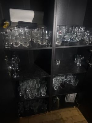 many glasses on the shelves in the room