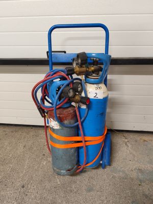 a blue cart with two cylinders and a hose