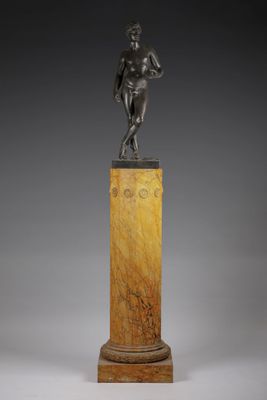 a bronze statue of a man standing on a pedestal