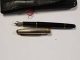 a pen and a wallet sitting on a table