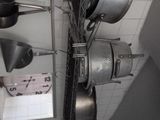 pots and pans hanging from the ceiling in a kitchen
