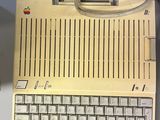 an apple computer sitting on a table next to a keyboard