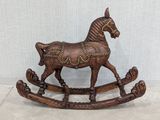 a wooden rocking horse that is sitting on the floor