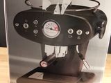 packaging of a coffee machine sitting on top of a wooden table