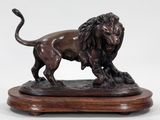 an image of a statue of a lion on a wooden base