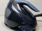 a black and blue steam iron sitting on a counter