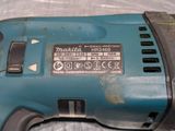 a close up of a corded drill on a table