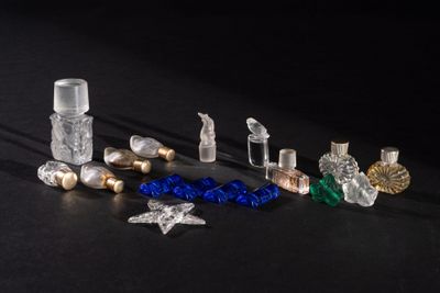 many different types of perfume bottles on a black surface