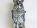 a blue and white vase sitting on a white surface