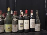bottles of wine are lined up on a shelf in front of a black background