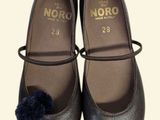 a pair of shoes with a pom - pom on them