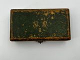 an old book sitting on top of a table next to a white wall