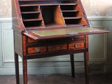a small desk with a drawer on top of it