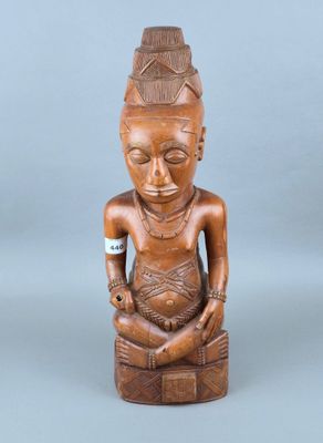 une image représentant une statue en bois d'une femme assise sur un tabouret