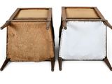 pair of wooden and leather side tables with a white canvas cover