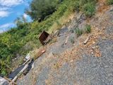 a pile of trash sitting on the side of a hill