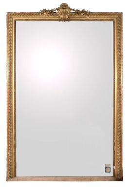 a gold framed mirror on a white wall with a white background