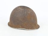 a rusty helmet on a white surface with a white background