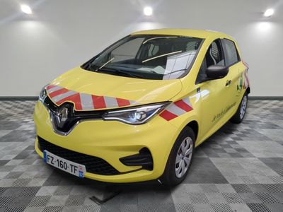 the yellow car is parked in the garage on the checkered floor