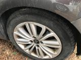 a close up of a car ' s tire on the side of the road