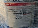 a large container wrapped in plastic sitting on the back of a truck