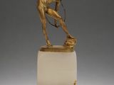 an image of a statue of a man holding a tennis racquet on a marble base