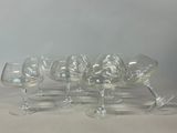 several empty wine glasses are lined up on a table