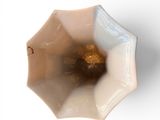 a white bowl with a brown flower inside of it