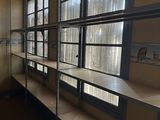 a room with shelves and a window in it