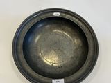 a close up of a metal bowl on a white surface