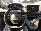 someone is sitting in the driver ' s seat of a car with their feet on the steering wheel