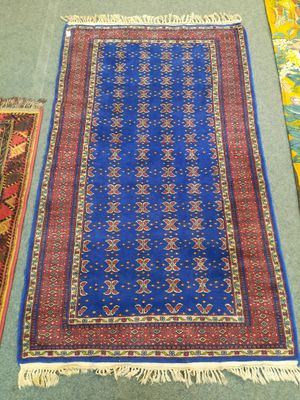 three rugs on the floor, one blue and one red