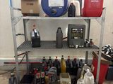 a picture of a garage with a lot of items on the floor