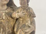an image of a statue of a woman holding a child